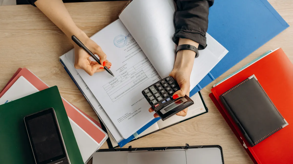 Financing and Budgets for First Flips: The Complete Guide Overhead view of calculator, notebooks, and financial paperwork