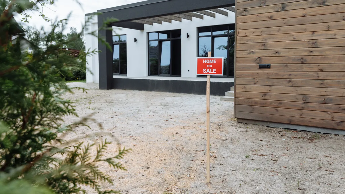 For sale sign outside a modern house